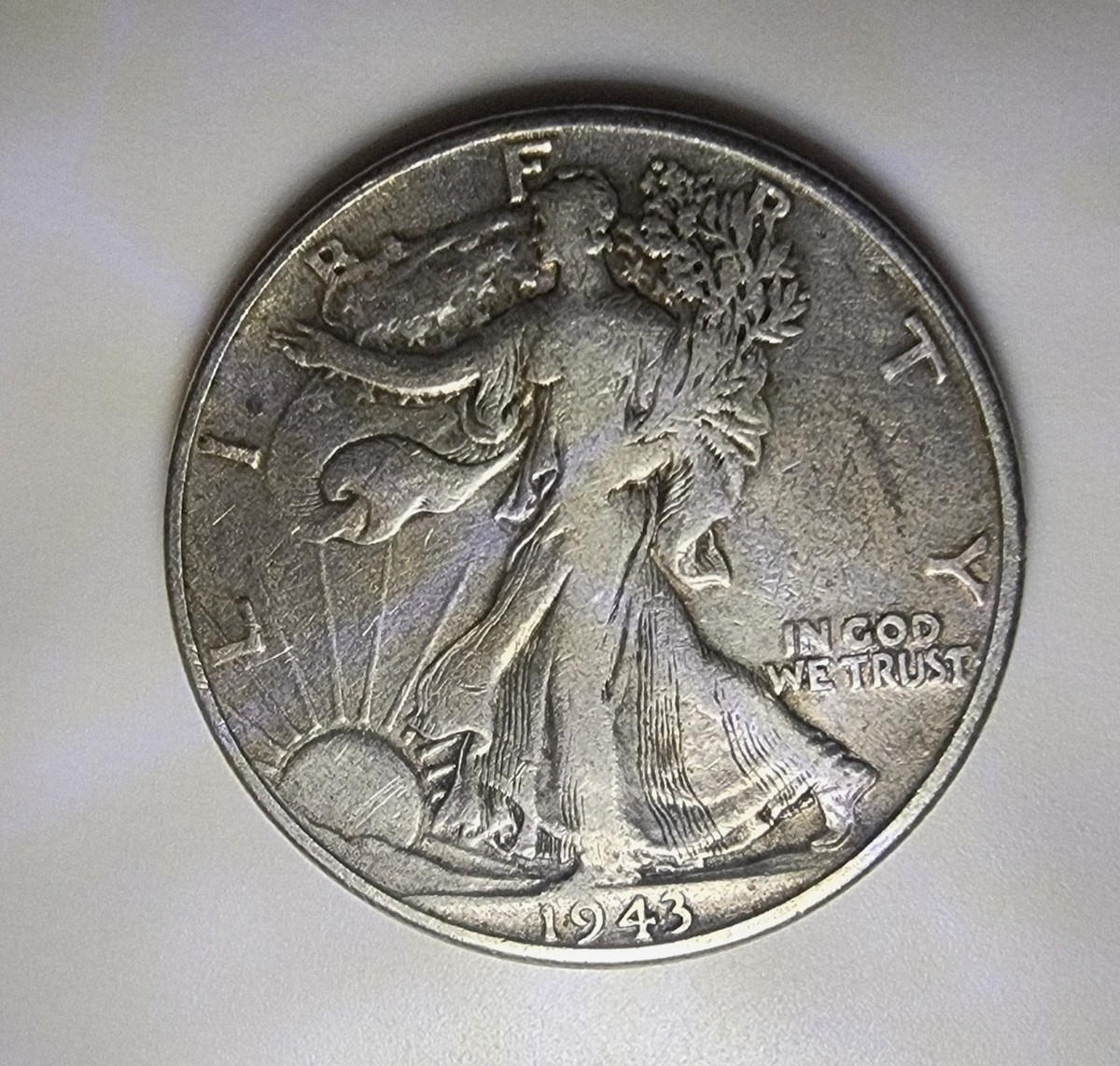 1943-S Walking Liberty half dollar close-up of Liberty's left hand showing the weak strike diagnostic