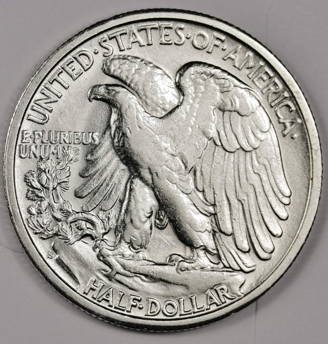 1943-S half dollar reverse close-up showing the missing AW designer initials area near the eagle's wing feathers